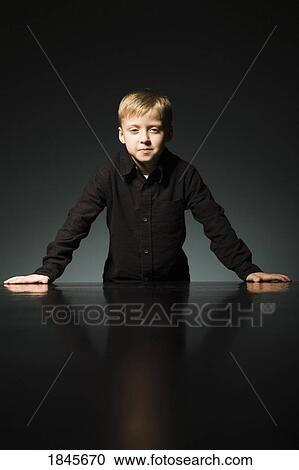 Male portrait; Boy standing at the end of a table View Large Photo Image Stock Image - Male portrait; Boy standing at the end of a table. Fotosearch