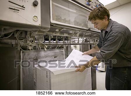 Man at a printing press View Large Photo Image Stock Photograph - Man at a printing press. Fotosearch