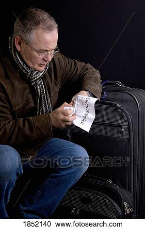 Stock Image - Man holding an eviction notice; Man moving out. Fotosearch