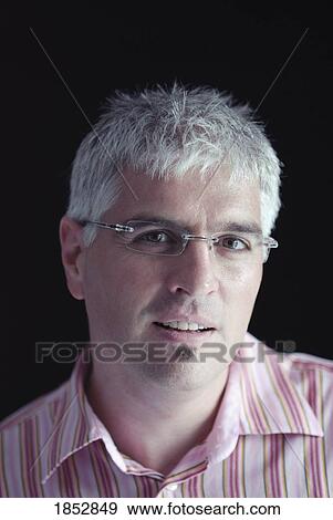 Stock Photo - Man; Portrait of Caucasian man wearing glasses. Fotosearch