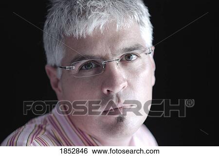 Stock Photograph - Man; Portrait of man wearing glasses. Fotosearch