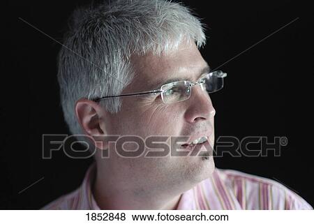 Stock Photo - Man; Portrait of man with glasses. Fotosearch