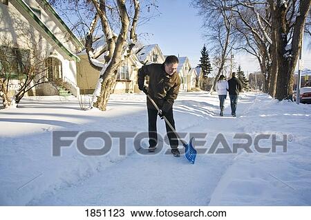 Man shovelling sidewalk View Large Photo Image Stock Image - Man shovelling sidewalk. Fotosearch