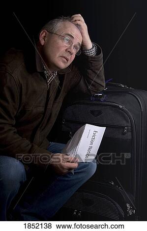 Man with suitcase; Man with an eviction notice View Large Photo Image Stock Photo - Man with suitcase; Man with an eviction notice. Fotosearch