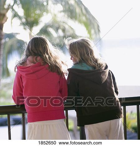 Stock Image - Maui, Hawaii, USA; Two girls enjoying the view . Fotosearch