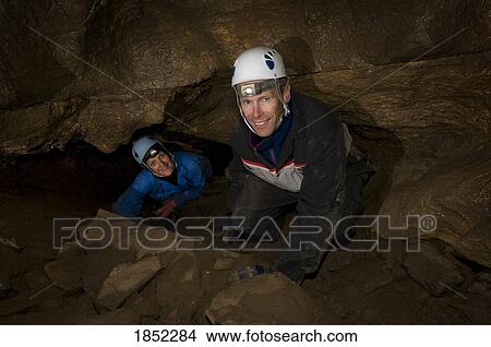 Picture - Men in a cave; spelunking. Fotosearch