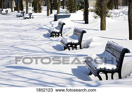 Stock Image - Montreal, Quebec, Canada; Benches in the snow. Fotosearch