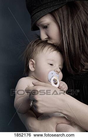 Stock Photograph - Mother and baby; Mother kissing baby. Fotosearch