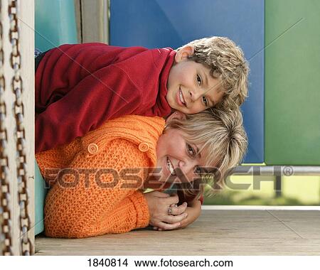 Picture - Mother and son on playground equipment. Fotosearch