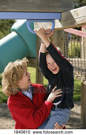 Stock Image - Mother and son on playground. Fotosearch