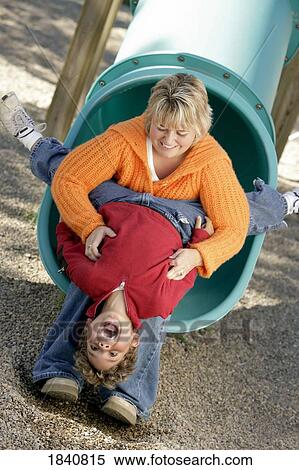 Stock Photography - Mother and son on slide. Fotosearch