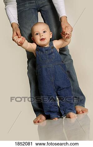 Mother helping toddler walk View Large Photo Image Stock Image - Mother helping toddler walk. Fotosearch