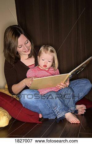 Stock Photo - Mother reading to her daughter. Fotosearch