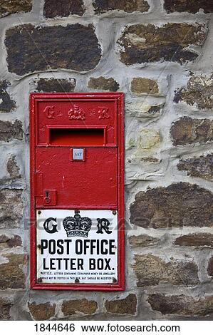 Stock Photograph - Northumberland, England; Old fashioned red wall letterbox. Fotosearch