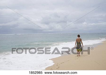 Nusa Dua beach, Nusa Dua, Bali, Indonesia; Woman walking on beach View Large Photo Image Stock Photography - Nusa Dua beach, Nusa Dua, Bali, Indonesia; Woman walking on beach. Fotosearch