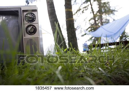 Old television in the grass View Large Photo Image Stock Photo - Old television in the grass. Fotosearch