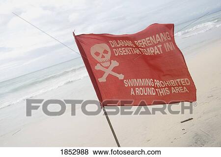 Stock Photo - Pecatu Village, Nusa Dua, Bali, Indonesia; Warning flag on Bali beach. Fotosearch