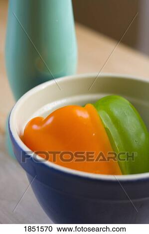 Peppers in a bowl; Orange and green pepper in a bowl View Large Photo Image Stock Image - Peppers in a bowl; Orange and green pepper in a bowl. Fotosearch