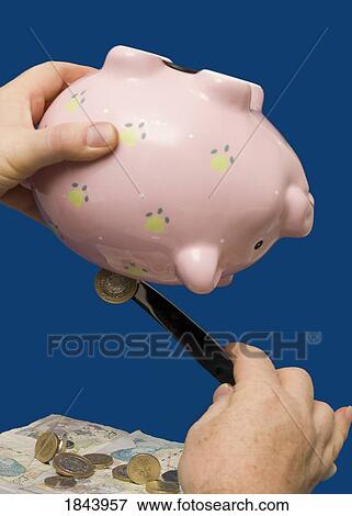 Person getting money out of piggy bank with knife View Large Photo Image Stock Photo - Person getting money out of piggy bank with knife. Fotosearch