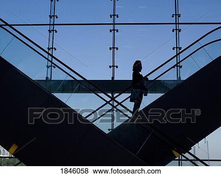 Person on escalator View Large Photo Image Stock Photo - Person on escalator. Fotosearch