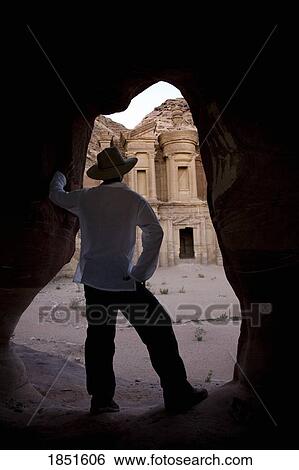 Stock Photograph - Petra, Jordan; Man with a hat enjoying the view. Fotosearch