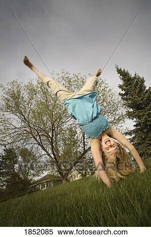 Playful girl; Girl doing a handstand View Large Photo Image Stock Photography - Playful girl; Girl doing a handstand. Fotosearch