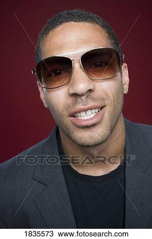 Portrait of a man wearing sunglasses View Large Photo Image Stock Image - Portrait of a man wearing sunglasses. Fotosearch