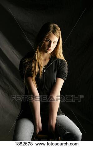 Portrait of a woman; Young woman looking sad View Large Photo Image Stock Photo - Portrait of a woman; Young woman looking sad. Fotosearch