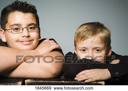 Portrait of two boys; Two brothers with their arms crossed View Large Photo Image Stock Photo - Portrait of two boys; Two brothers with their arms crossed. Fotosearch