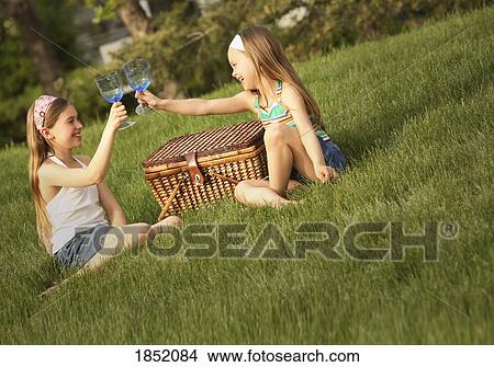 Portrait of two girls; Two girls having a picnic View Large Photo Image Picture - Portrait of two girls; Two girls having a picnic. Fotosearch
