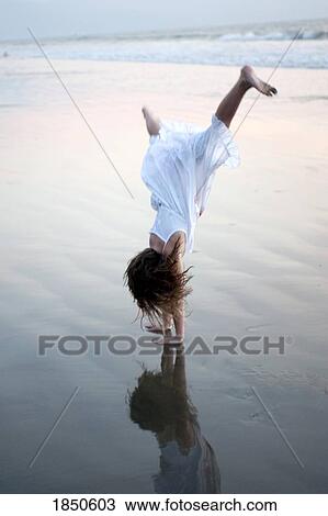 Puerto Vallarta, Mexico; Girl doing a cartwheel on the beach View Large Photo Image Stock Image - Puerto Vallarta, Mexico; Girl doing a cartwheel on the beach. Fotosearch