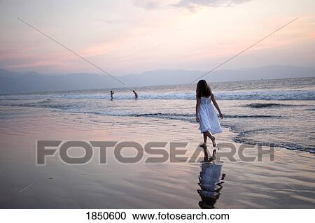 Stock Image - Puerto Vallarta, Mexico; Girl walking on the beach . Fotosearch