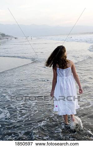Stock Photo - Puerto Vallarta, Mexico; Girl walking on the beach . Fotosearch