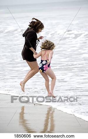 Puerto Vallarta, Mexico; Mother and daughter jumping in the water View Large Photo Image Stock Photograph - Puerto Vallarta, Mexico; Mother and daughter jumping in the water. Fotosearch