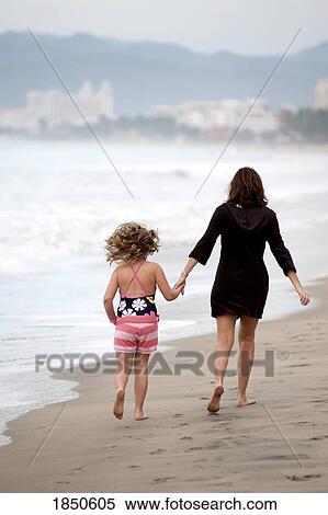 Puerto Vallarta, Mexico; Mother and daughter walking on the beach View Large Photo Image Stock Photography - Puerto Vallarta, Mexico; Mother and daughter walking on the beach. Fotosearch