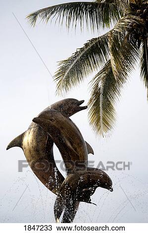 Stock Image - Puerto Vallarta, Mexico; Statue of jumping dolphins . Fotosearch