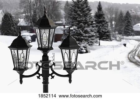 Picture - Quebec, Canada; Lamppost in a winter scene. Fotosearch