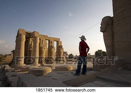 Stock Photography - Ramesseum, Memorial temple of Ramses II, West Bank of Luxor, Egypt; man looking at temple. Fotosearch