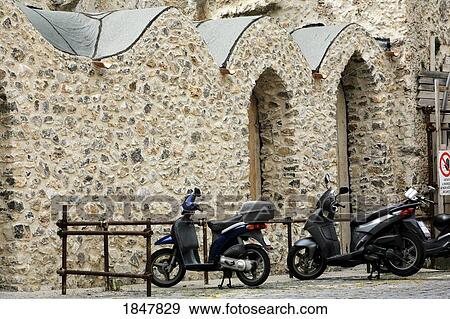 Ravello, Campania, Italy; Mopeds parked outside a stone building View Large Photo Image Stock Photo - Ravello, Campania, Italy; Mopeds parked outside a stone building. Fotosearch