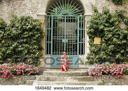 Stock Image - Ravello, Italy; Woman sitting on steps. Fotosearch
