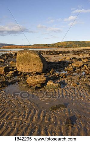 Stock Photography - Rippled sand and rocks on a beach, Argyll and Bute, Scotland. Fotosearch