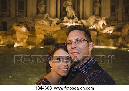 Stock Image - Rome, Italy; Couple standing in front of fountain. Fotosearch