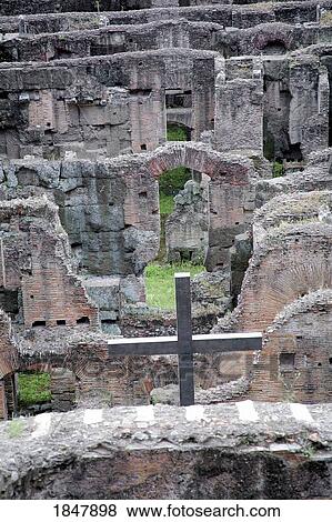 Stock Photo - Rome, Italy; Metal cross erected in the catacombs of the Colosseum. Fotosearch