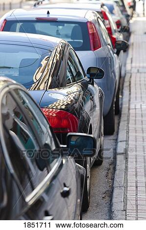 Stock Image - Row of parked cars on a street. Fotosearch