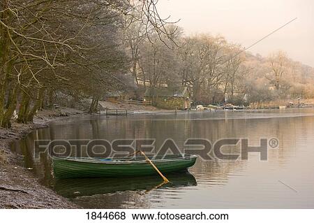 Rowboat sitting at the shore of a lake, Cumbria, England View Large Photo Image Stock Photo - Rowboat sitting at the shore of a lake, Cumbria, England. Fotosearch