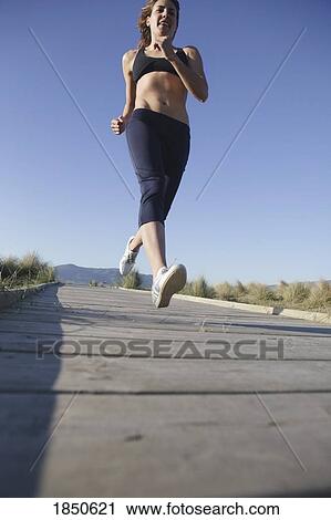 Stock Image - Running on the sidewalk. Fotosearch
