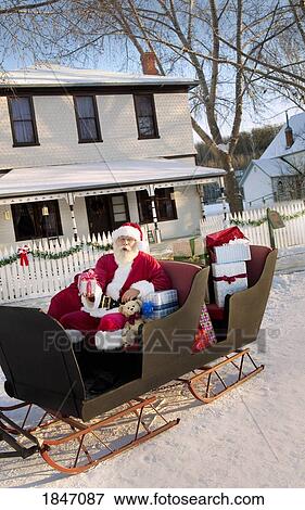 Stock Photo - Santa Claus on his sled. Fotosearch
