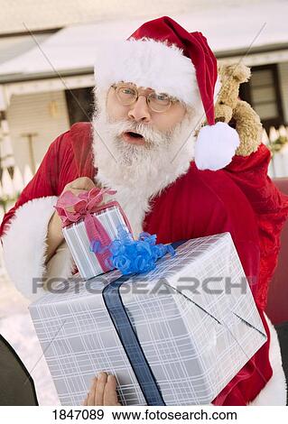 Stock Photo - Santa Claus with gifts. Fotosearch