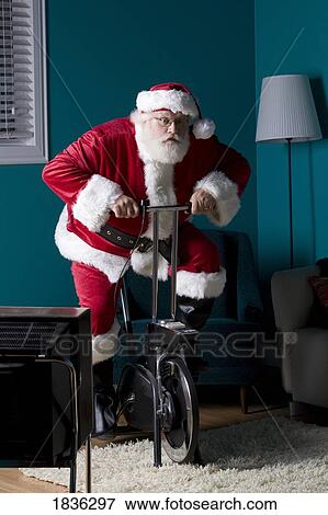 Stock Photo - Santa riding stationary bike. Fotosearch