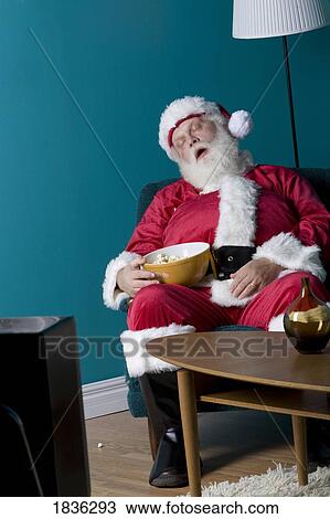 Stock Image - Santa sitting and sleeping. Fotosearch
